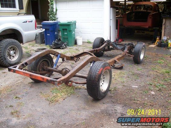 Vehicle frame with wheels and suspension components, orange front bumper