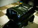1990 Ford Bronco - A freshly painted fuel tank is shown, with a partial view of a vehicle in the background.