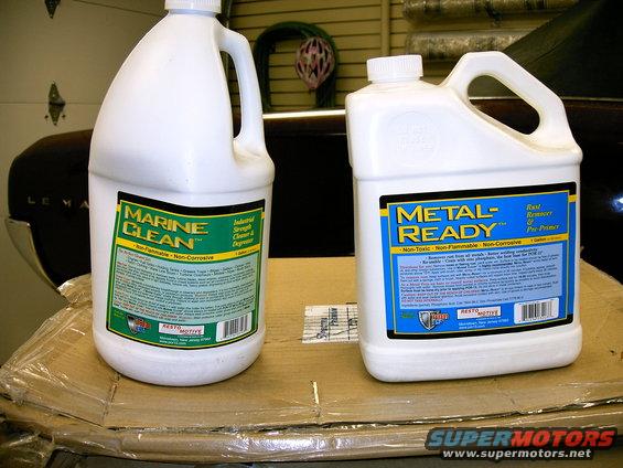 Two bottles of cleaning supplies, one labeled Marine Clean and the other Metal-Ready, sit on cardboard