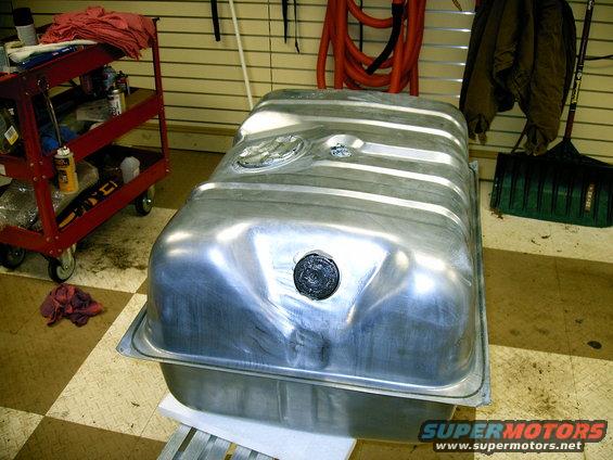 Fuel tank with two circular openings and a black cap