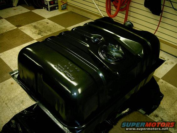 Black fuel tank with embossed text and circular emblem