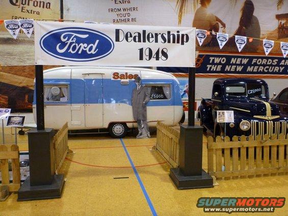 1948 Ford dealership display a blue and white trailer and a dark blue Ford pickup truck with a yellow stripe