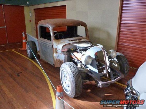 Rat rod pickup truck, front end exposed, rusty body panels