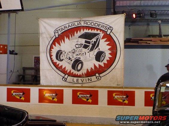 Banner with a hot rod illustration and text 'TARARUA RODDERS LEVIN'. Red and white jagged circle behind the hot rod