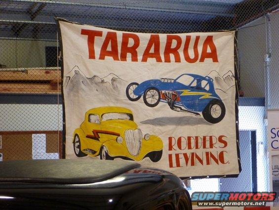 Banner with yellow and blue hot rods, "TARARUA RODDERS LEVIN INC."