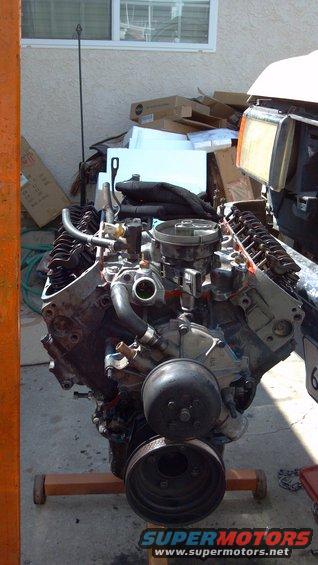 Engine on stand, front view. Water pump and pulley visible