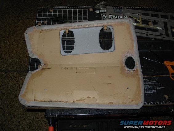 visor09.jpg I carefully pulled the fabric over the edge, keeping the edge straight & smooth, and working the E6000 all the way through it.  Then I applied another small bead of E6000 to glue the front & back edges together.

Note that the holes I cut for the vanity lights are MUCH too large.  I had to peel this cover again, clean all the new foam off, and start over.  Fortunately, I had enough material to redo it, and a little to spare.  So I made marks on the cardboard showing the minimum size for the holes, and then cut inside those marks on the next try.