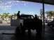 1986 Ford Bronco - Two people are working on a 1986 Ford Bronco inside a garage.