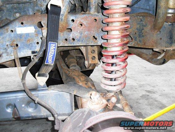 McKenzie tow strap attached to rusty suspension components