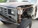 1986 Ford Bronco - Front view of a disassembled 1980 Ford Bronco, showing the grille and suspension components.
