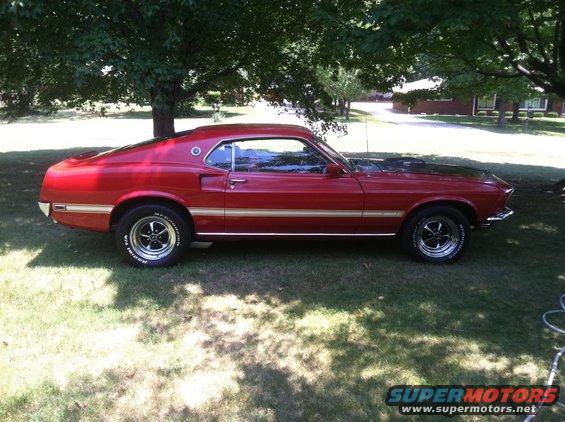 1969 Ford Mustang Mach 1 parked on grass under trees, side view