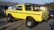 1978 Ford Bronco - This lifted yellow Ford Bronco is parked in front of a residential home.