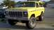 1978 Ford Bronco - A yellow 1979 Ford pickup truck is shown from a 3/4 front angle, modified with a lift kit and large tires.
