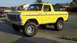 1978 Ford Bronco - A bright yellow 1978 Ford Bronco is shown from a three-quarter front view, lifted with large off-road tires.