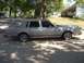 1988 Lincoln Town Car - This 1988 Lincoln Town Car is parked on a paved surface with a house and trees in the background.