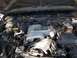 1988 Lincoln Town Car - The engine compartment of a vehicle, showing the V8 engine and various hoses and wires.