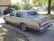 1988 Lincoln Town Car - A silver 1988 Lincoln Town Car is parked in a driveway next to a garage containing garage.