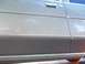 1988 Lincoln Town Car - Close-up of a silver car door with chrome accents and a dark gray lower panel.