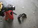 1988 Ford Bronco - Vehicle axle part and housing on jack stands, with a separate bracket on the floor.