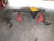 1988 Ford Bronco - A rear axle assembly is supported by red jack stands on a concrete floor.