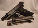 2003 Ford Crown Victoria - Kimber 1911 pistol and two magazines are displayed on a white surface.