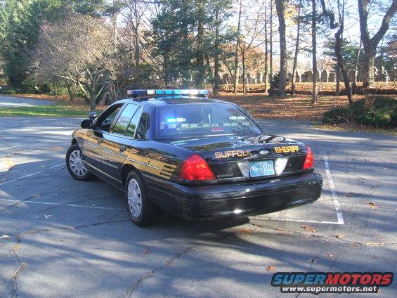 Black 2011 Ford Crown Victoria police car with Suffolk Sheriff markings and light bar