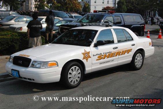 White 2011 Ford Crown Victoria Sheriff's car, front 3/4 view, with light bar and Suffolk County Sheriff markings