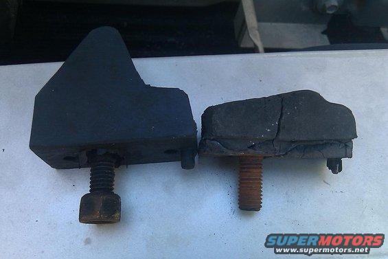 Two rubber bumpers, one new and one cracked, with bolts