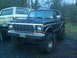 1979 Ford Bronco - A black 1979 Ford Bronco with a lifted suspension is parked next to another Bronco.