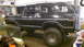 1979 Ford Bronco - This black Ford Bronco is parked inside a garage, showing its lifted suspension and off-road tires.