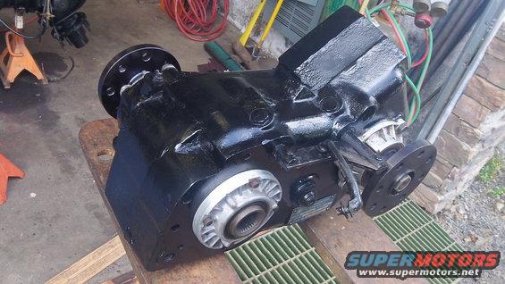 black transfer case on a wooden surface, with shop equipment in background