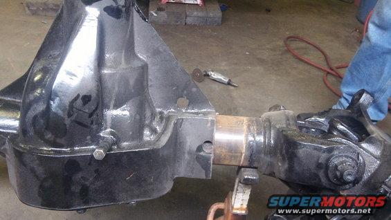 Close-up of a vehicle's rear axle assembly, possibly undergoing modification