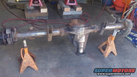 Rear axle assembly on jack stands in a garage