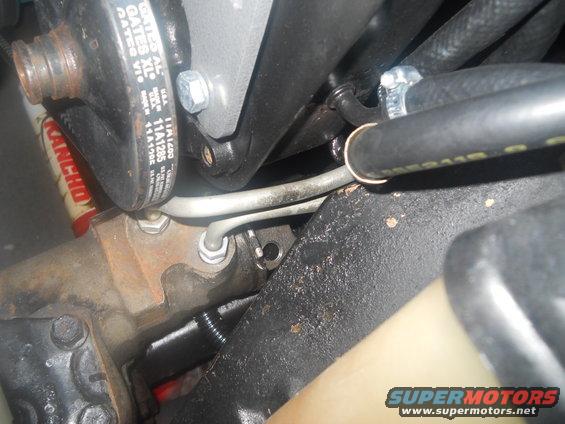 Close-up of power steering pump with Gates XL belt and hoses. Supermotors.net logo visible
