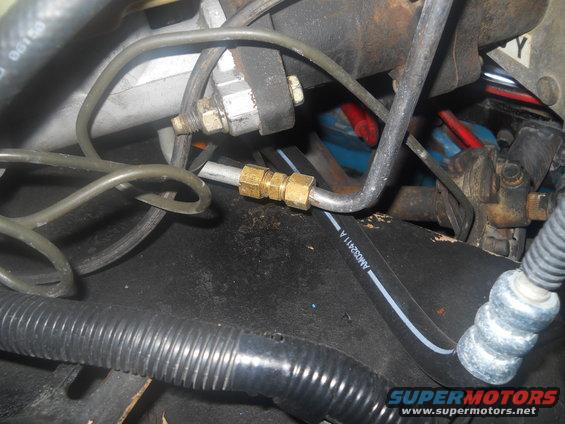 close-up of brake lines and master cylinder with brass fittings