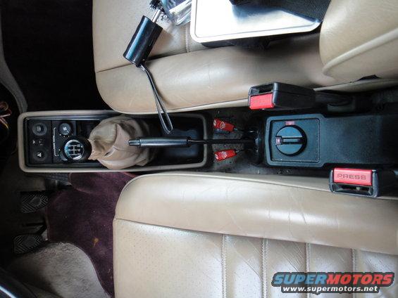 Interior view of 1986 Porsche 911 center console with manual shifter and seatbelts