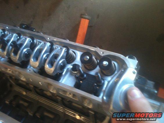 Close-up of an engine's valve train with rocker arms and springs
