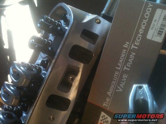 Engine cylinder head and pushrod box with text 'The Absolute Leader In Valve Train Technology'