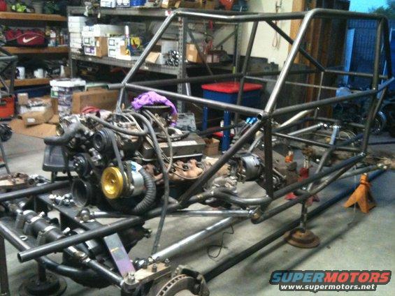 off-road buggy chassis with engine installed, in a workshop