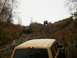 1979 Ford Bronco - Multiple off-road vehicles navigate a challenging, wooded incline during an autumn excursion.