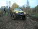 1979 Ford Bronco - Modified yellow Jeep Cherokee navigates a steep dirt incline during an off-road excursion.