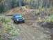 1979 Ford Bronco - A dark gray Jeep Cherokee XJ navigates a dirt path through an autumn forest.