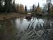 1979 Ford Bronco - Two 4x4 vehicles are shown traversing a challenging muddy terrain with deep tire tracks and standing water.