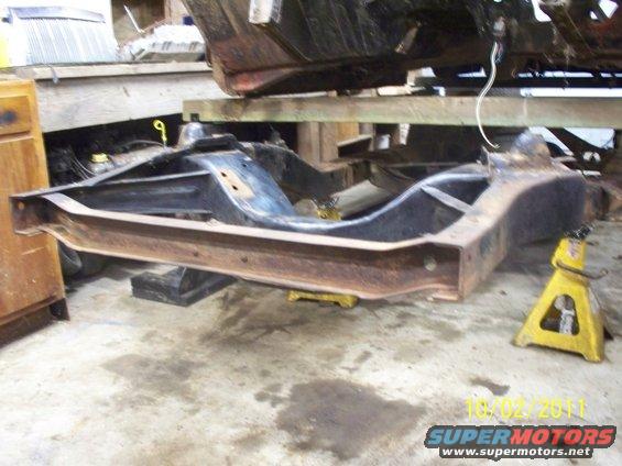 Vehicle frame on yellow jack stands, date stamp 10/02/2011