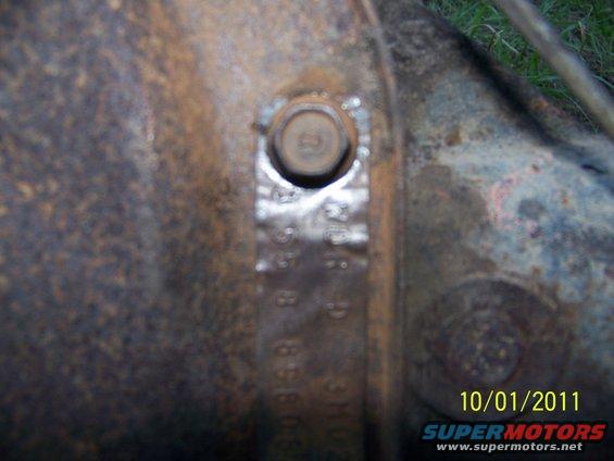 Differential housing with stamped numbers and a bolt