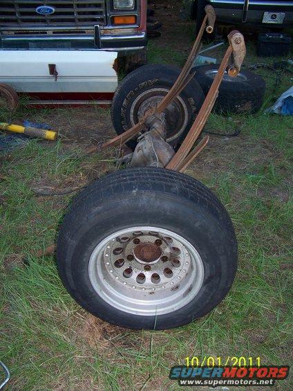 Rear axle assembly with leaf springs and tires, part of a 1986 Ford Bronco