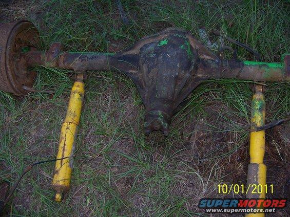 Dana 60 axle with yellow shocks on the ground