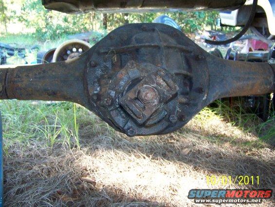 Rusty rear axle differential assembly, likely from a truck or SUV