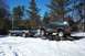 1995 Ford F-250 - Ford F-250 tows a lifted Ford Bronco on a trailer through a snowy landscape.