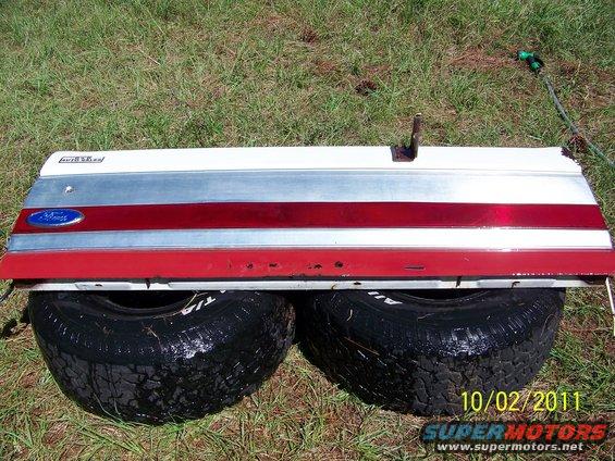 1986 Ford Bronco tailgate with red and silver trim and blue Ford badge